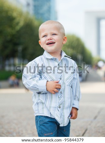 Portrait of the cute little boy walking to la Defense, Paris