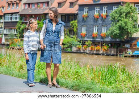 Tourists. Beautiful mother and daughter walking in europe city.