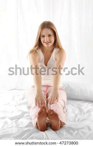 young beautiful happy woman on bed