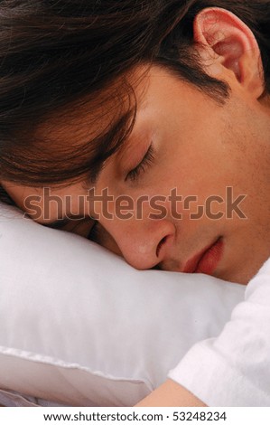 Young man sleeping in bed