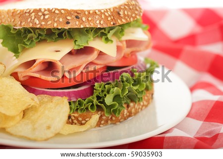 Deliciously fresh ham and cheese sandwich with crisp potato chips