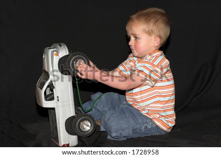 Boy playing with toy truck