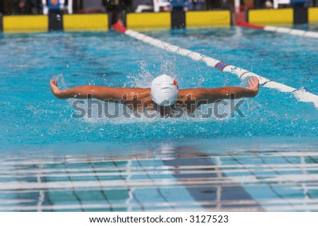 Outstretched arms in the butterfly swim event
