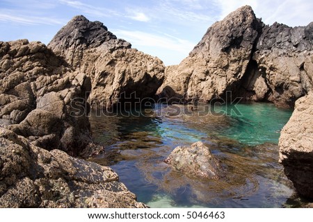A large rock pool at kynance cove england