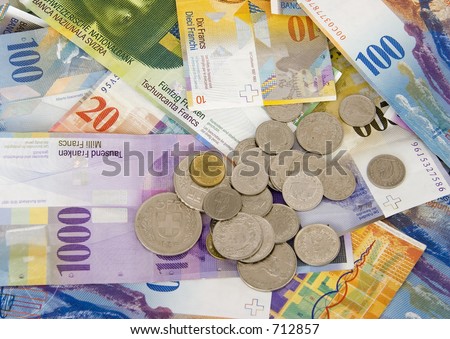 Close-up of Swiss currency bank notes and coins (Swiss Francs).