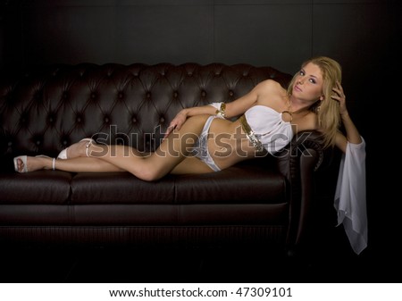 portrait of young sexy girl lying down on sofa