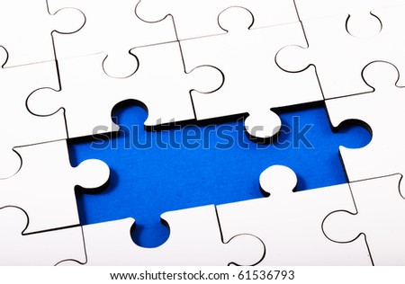 White Jigsaw with two pieces missing with blue underneath