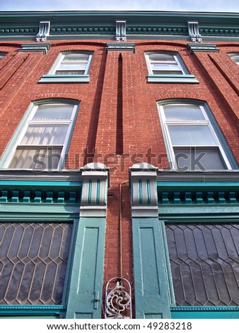 Red brick building with attractive architectural accents in aqua green.