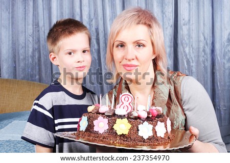 mother and child with the birthday cake