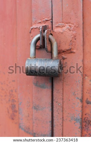 padlock on the red garage gate