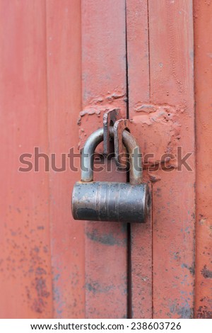 padlock on the red garage gate