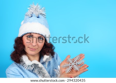 pretty young Snow Maiden with the snowflake in her hand