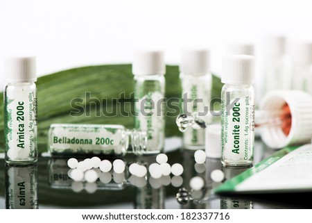 Bottles with homeopathic remedies. Aconite, arnica and belladonna pills. Selective focus.
