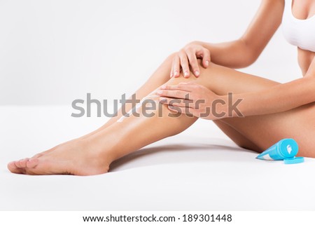 Body-care of female Smooth legs with a body lotion.