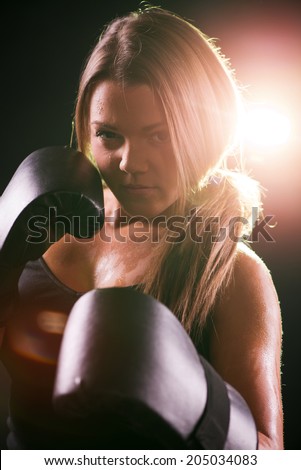 Portrait of Young beautiful boxing girl standing with a guard ready to punch.