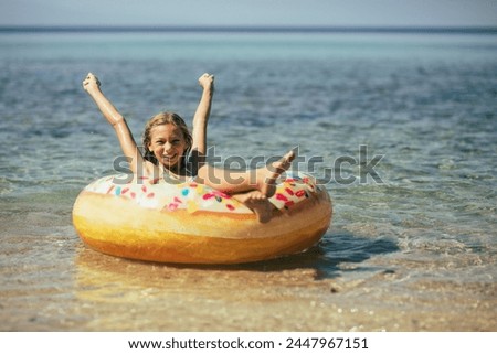 Similar – Image, Stock Photo beautiful teenager girl floating on pink donuts in a pool. Wearing sunglasses and smiling. Fun and summer lifestyle