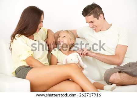 Portrait of a beautiful Happy family sitting at home and talking