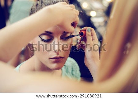 Make-up artist applying the mascara to model. Close up.  Foto stock © 