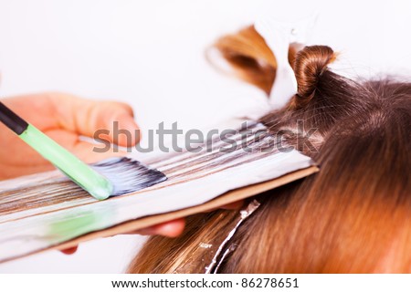 Coloring hair with hair coloring brush / Close-up