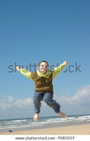 Active boy on the beach on nice winter day