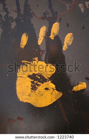 Yellow hand on black surface.