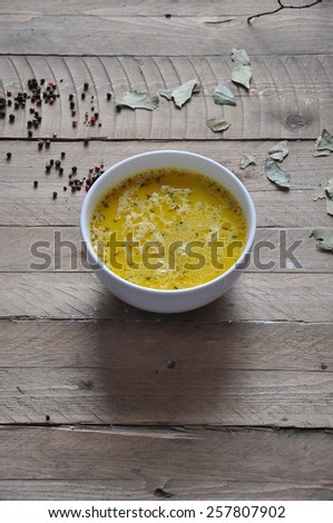 Cheese soup with spices on wooden