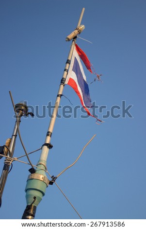 Storms battered the Thai flag on the mast of a boat