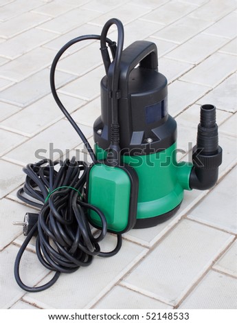 Pump for irrigation of plants is on  a concrete   floor