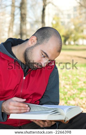 student reading book in park