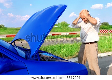 Dear me ! Businessman with his hands to his head and defected a car