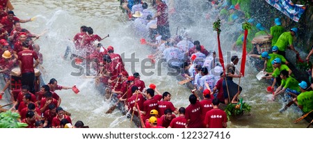 FOSHAN CITY - JUNE 5: Foshan City hold dragon boat festival, many 40 Dragon Boat gathered in Foshan River, lively and extraordinary June 5, 2012 in Foshan City, China