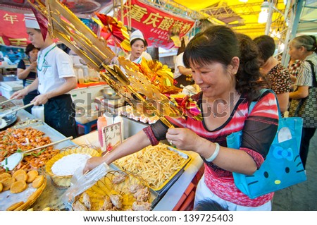 FOSHAN CITY Ã¢Â?Â? MAY 23: Foshan City in 2013 food festival held at Xiqiao Plaza, 100 restaurants to participate in the activities, people have to buy and food taste like May 23, 2013 in Foshan, China
