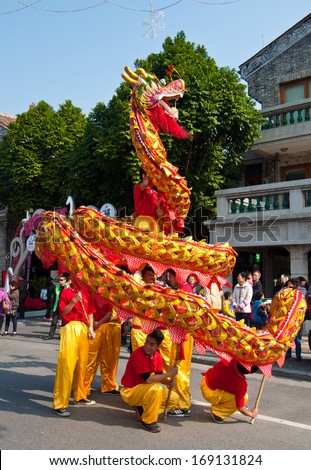 FOSHAN CITY-Dec 21: In order to meet the 2014 new year, dragon dance and lion dance teams performed at the Foshan square,attracted a large number of people to watch Dec 21, 2013 in Foshan, China