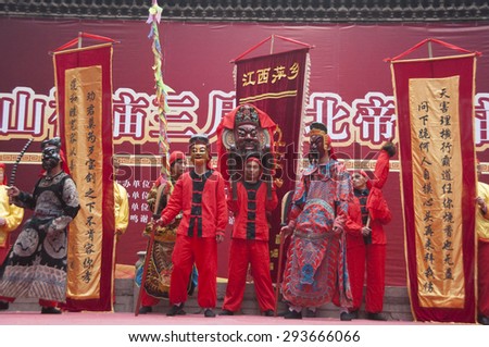 FOSHAN - April 4:Taoist god's birthday, temples non-material cultural exhibitions, from pingxiang masked men dressed in traditional costumes performing on the stage April  4, 2011 in Foshan, China