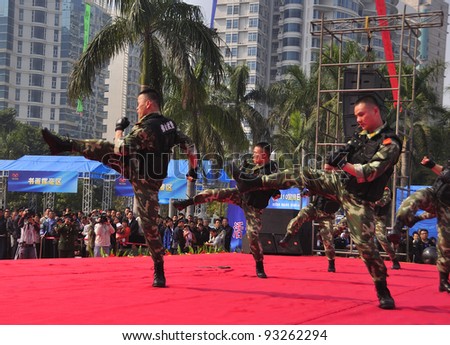 FOSHAN CITY, CHINA - JANUARY 10: Unidentified armed policemen in action display Chinese martial arts on stage during Police Public Open Day at the park January 10, 2012 in Foshan, China