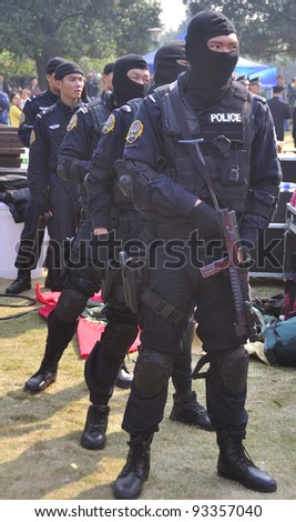 FOSHAN CITY, CHINA - JANUARY 10: Unidentified special policemen display use of firearms during Police Public Open Day at the park January 10, 2012 in Foshan, China