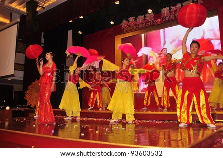 FOSHAN CITY - JANUARY 18: Merchants Bank Employees Dressed In Traditional Costumes, Song And Dance On New Year's Party To Celebrate The Arrival Of Chinese New Year January 18, 2012 in Foshan, China