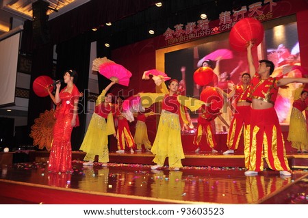 FOSHAN CITY - JANUARY 18: Merchants Bank Employees Dressed In Traditional Costumes, Song And Dance On New Year's Party To Celebrate The Arrival Of Chinese New Year January 18, 2012 in Foshan, China