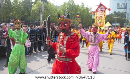 FOSHAN, MARCH 23: Chinese People Wearing Masks In The Street Parade, In Orderto Celebrate The Birthday Of The Temple Of God, Foshan Temple Organized Apeople\'s Parade March 23, 2012 in Foshan, China