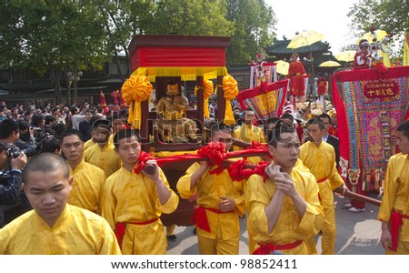 FOSHAN, MARCH 23: Foshan Temple Held A Parade To Celebrate The Birthday Of Thetemple Of God, Many A Man Carrying God\'s Bridge In The Parade March 23, 2012in Foshan, China