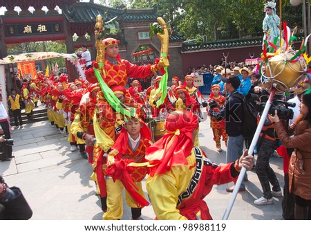 FOSHAN- MARCH 23: Foshan temple held a parade to celebrate the birthday of the temple of God, many men make up the dragon in the parade March 23, 2012 in Foshan, China