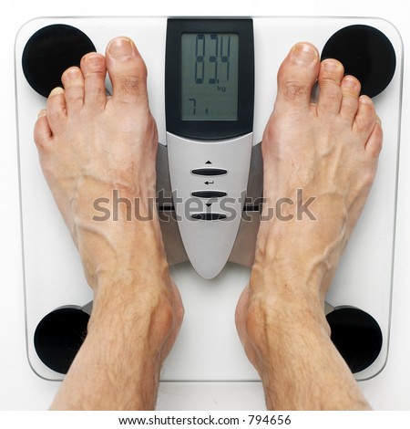men\'s feet on an electronic, design balance scale