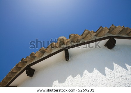 roof from a Spanish villa typical roofing tiles, blue sky)