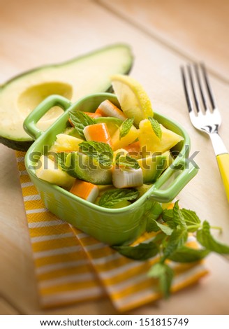 salad with avocado surimi and pineapple, selective focus
