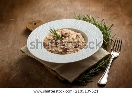 Similar – Rosemary on risotto with rabbit and mushrooms