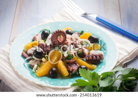 octopus salad with sliced orange,  selective focus