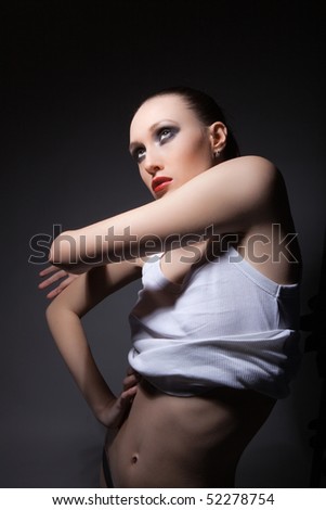 Unusual portrait of brunette skinny model with plumpy red lips and agressive look