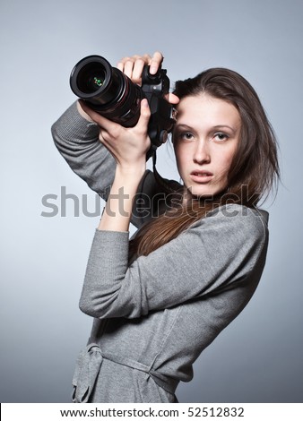 Unusual portrait of beautiful female photographer shooting