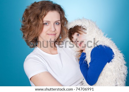 Happy mom and child embracing, closeup portrait