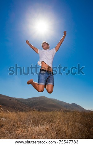 Happy young man jump in the mountains
